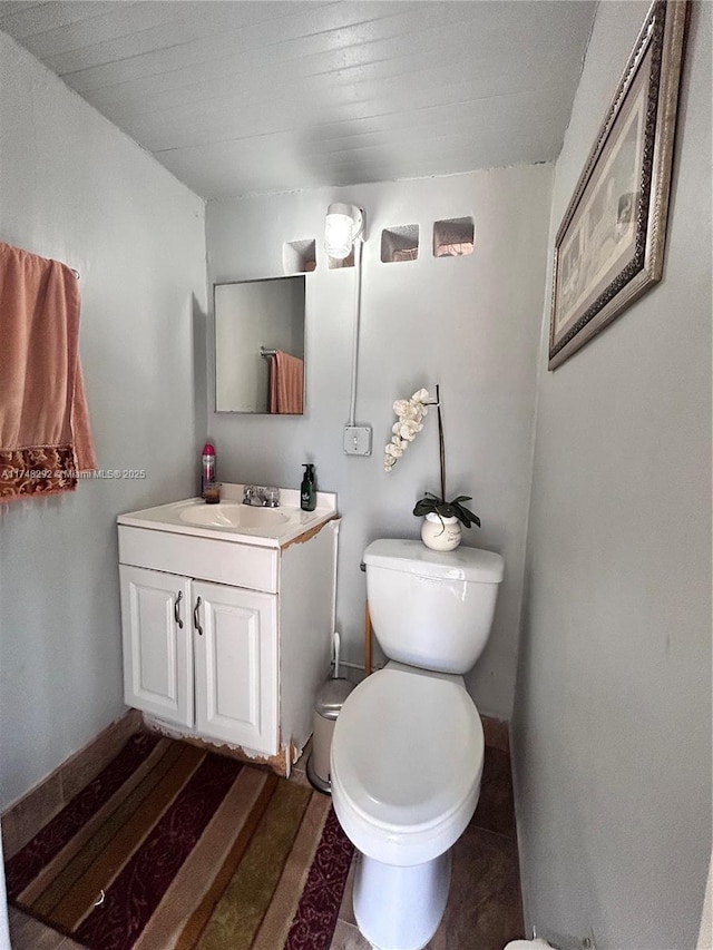 bathroom featuring toilet and vanity