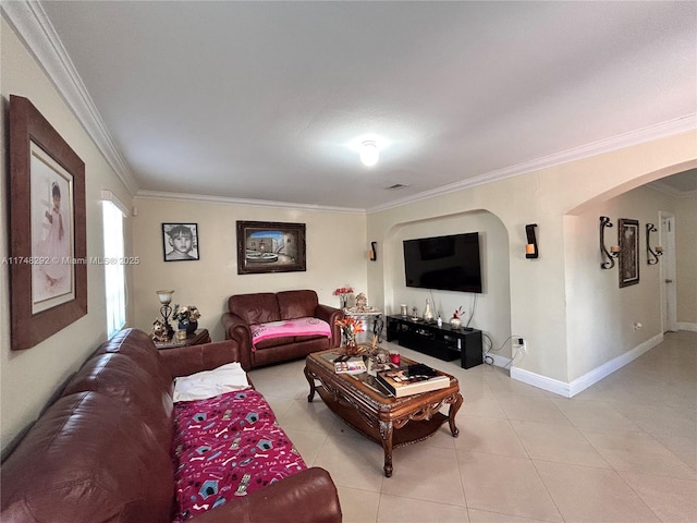 living area with visible vents, arched walkways, crown molding, light tile patterned floors, and baseboards