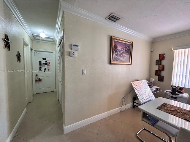 office area with crown molding, light tile patterned floors, baseboards, and visible vents