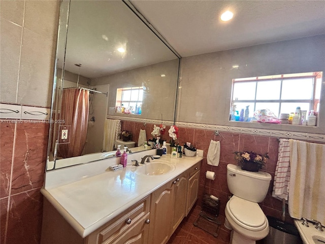 full bathroom with toilet, tile walls, a shower with curtain, and vanity