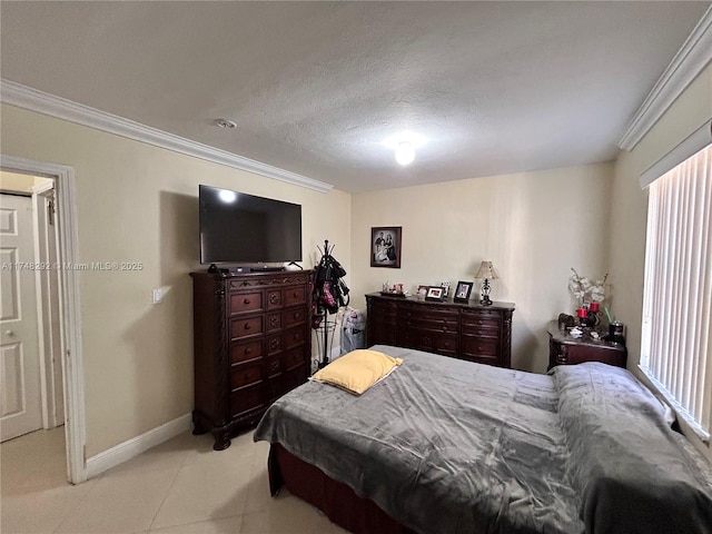 bedroom featuring light tile patterned floors, crown molding, and baseboards