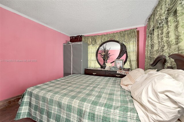 1412 NW 63rd Ave, Margate, FL 33063 - bedroom featuring baseboards, wood finished floors, a textured ceiling, and ornamental molding