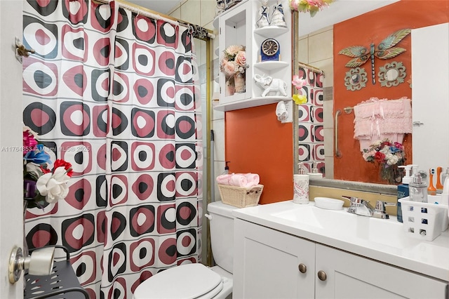 bathroom featuring curtained shower, toilet, and vanity