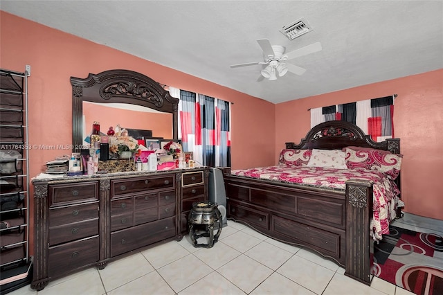 bedroom featuring light tile patterned floors, visible vents, and ceiling fan