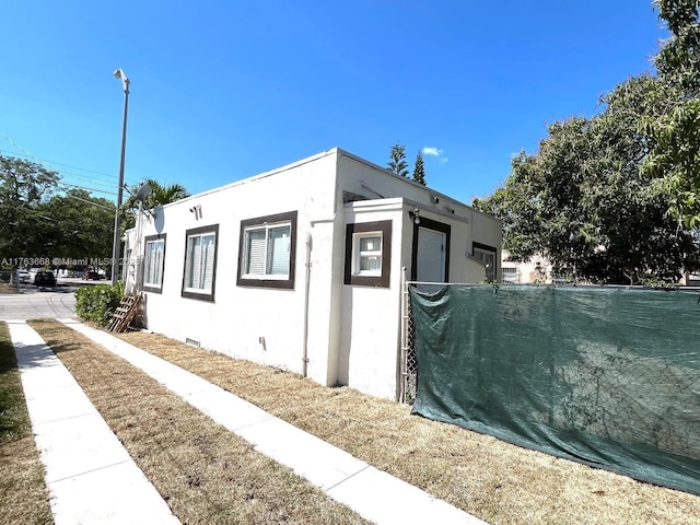 929 SW 12th Ave, Miami, FL 33130 - view of side of home featuring crawl space and stucco siding