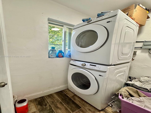 929 SW 12th Ave, Miami, FL 33130 - washroom featuring laundry area, baseboards, dark wood-style flooring, and stacked washing maching and dryer