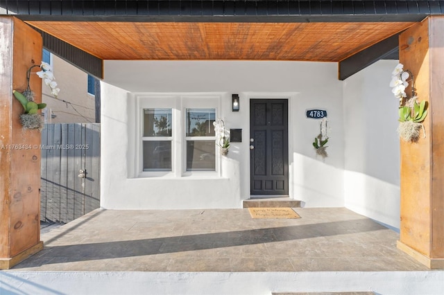 view of exterior entry featuring stucco siding