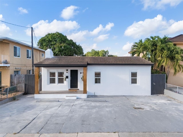 ranch-style home with fence and stucco siding