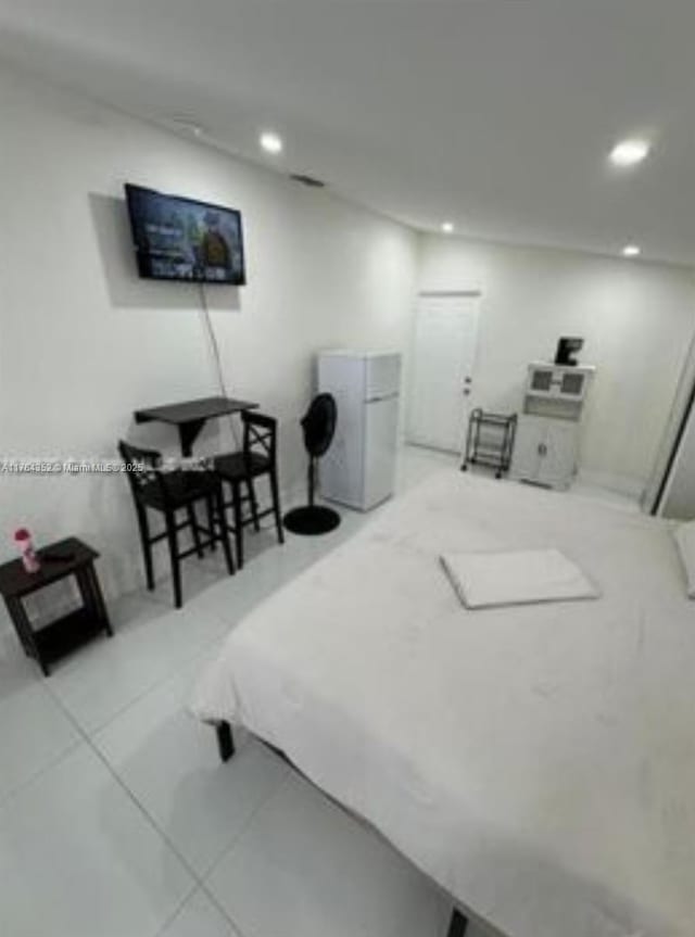 bedroom with recessed lighting and freestanding refrigerator