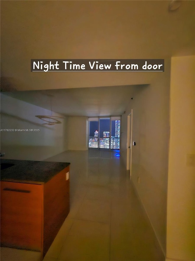 hallway with tile patterned floors and expansive windows