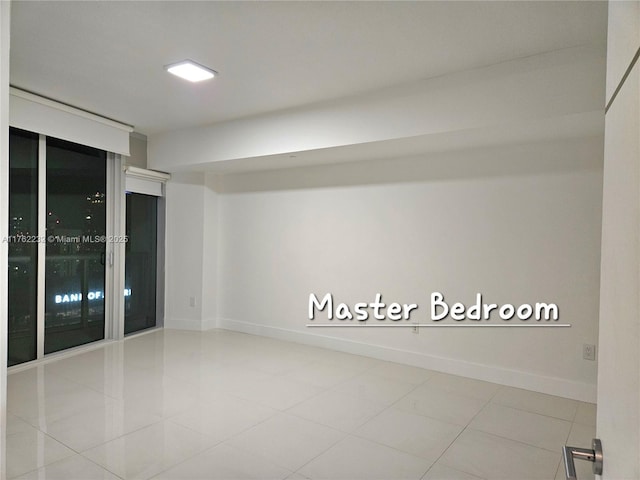 tiled spare room with baseboards