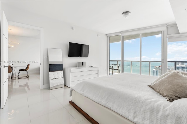 bedroom with access to outside, multiple windows, and light tile patterned flooring