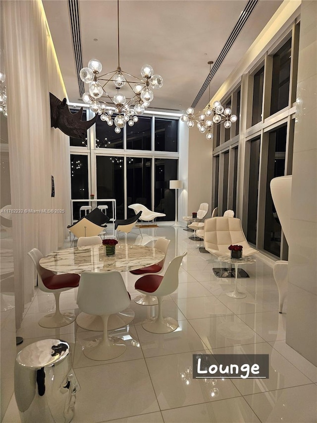 tiled dining room with an inviting chandelier