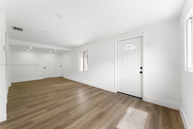 entryway featuring visible vents, recessed lighting, baseboards, and wood finished floors