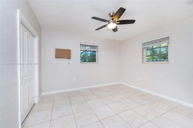 unfurnished room featuring baseboards and ceiling fan