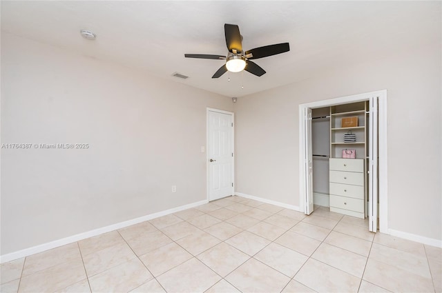 unfurnished bedroom with baseboards, visible vents, a closet, and ceiling fan