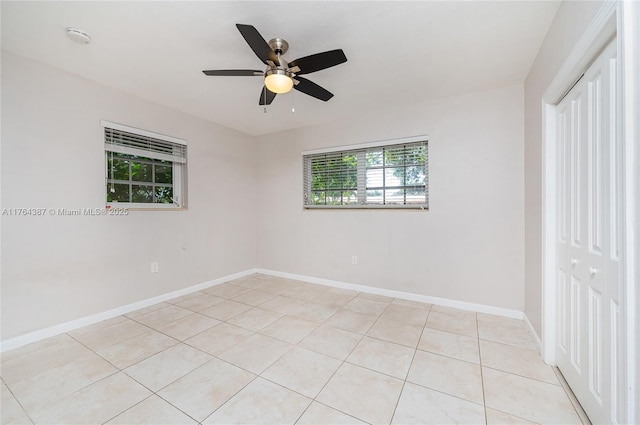 unfurnished bedroom with a ceiling fan, light tile patterned floors, baseboards, and a closet