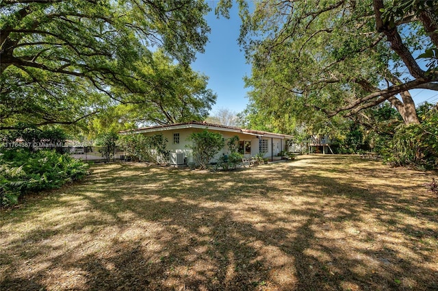 view of yard featuring cooling unit and fence