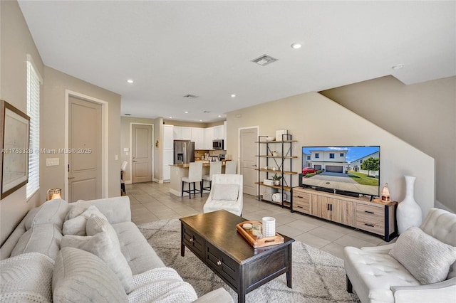 living area featuring light tile patterned floors, visible vents, and recessed lighting