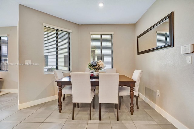 dining area featuring light tile patterned floors and baseboards