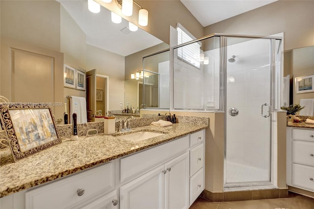 full bath featuring vanity, a shower stall, and tile patterned floors