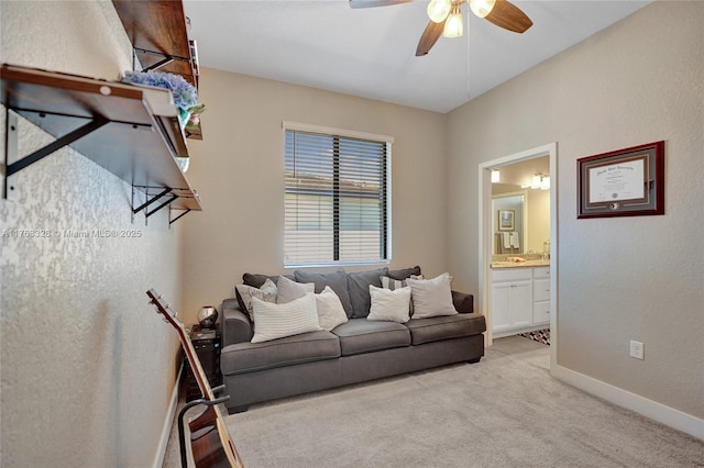 living room with light colored carpet, baseboards, and a ceiling fan