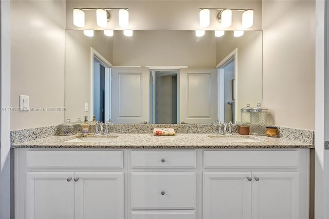 bathroom with a sink and double vanity