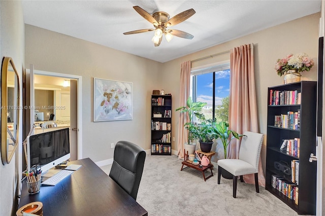 carpeted office with baseboards and ceiling fan