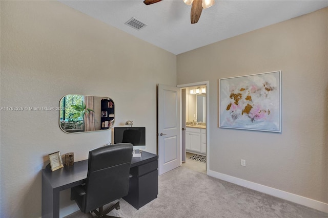 office space featuring ceiling fan, baseboards, visible vents, and light carpet