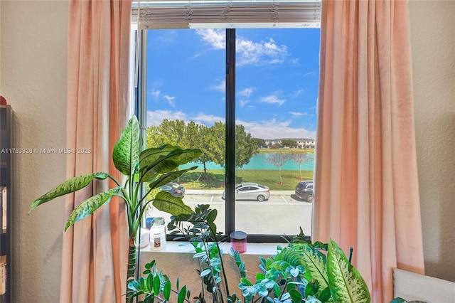 interior details featuring a water view and a textured wall