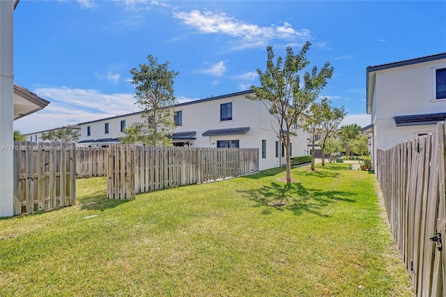 view of yard with a residential view and fence