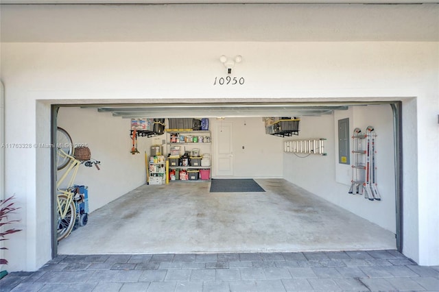 garage with electric panel and driveway