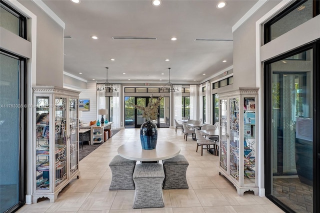 interior space featuring recessed lighting, french doors, and ornamental molding