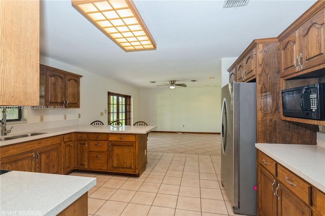 27820 SW 164th Ct, Homestead, FL 33031 - kitchen with a ceiling fan, black microwave, a sink, freestanding refrigerator, and a peninsula