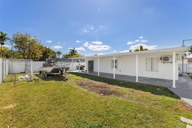 view of yard with a fenced backyard, a patio, and ac unit