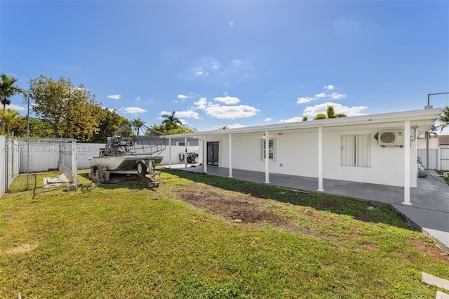 view of yard with a patio area, a fenced backyard, and ac unit