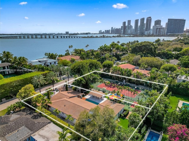 birds eye view of property featuring a city view and a water view