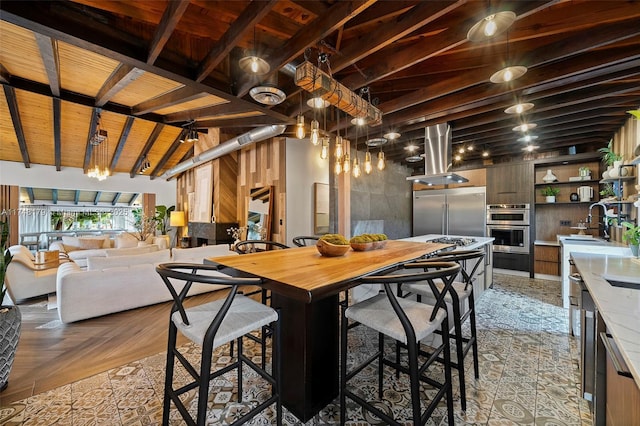 dining room with wooden ceiling and vaulted ceiling with beams