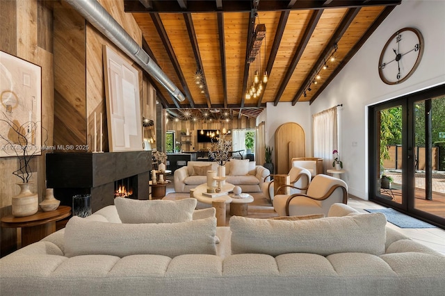 living room with beam ceiling, wood ceiling, and a wealth of natural light