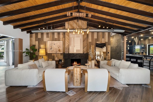 living room featuring a premium fireplace, beamed ceiling, wooden ceiling, and dark wood-style flooring