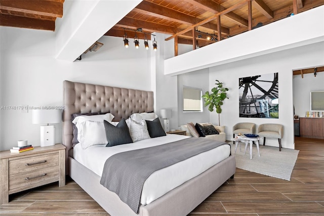 bedroom featuring beam ceiling, dark wood finished floors, and wood ceiling