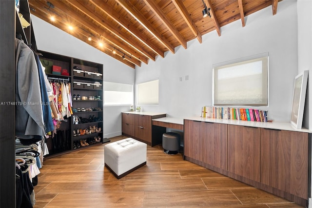 interior space featuring lofted ceiling with beams and wood finished floors