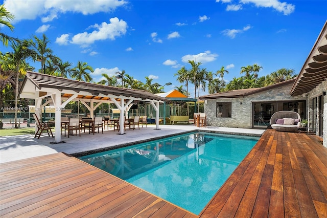 pool with a gazebo, fence, and a patio area