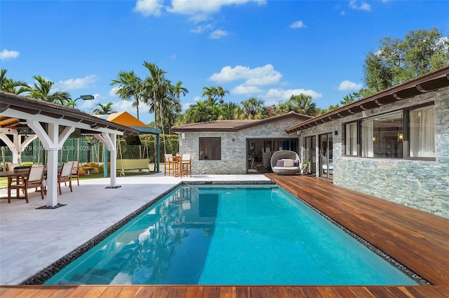 outdoor pool with a gazebo and a patio area