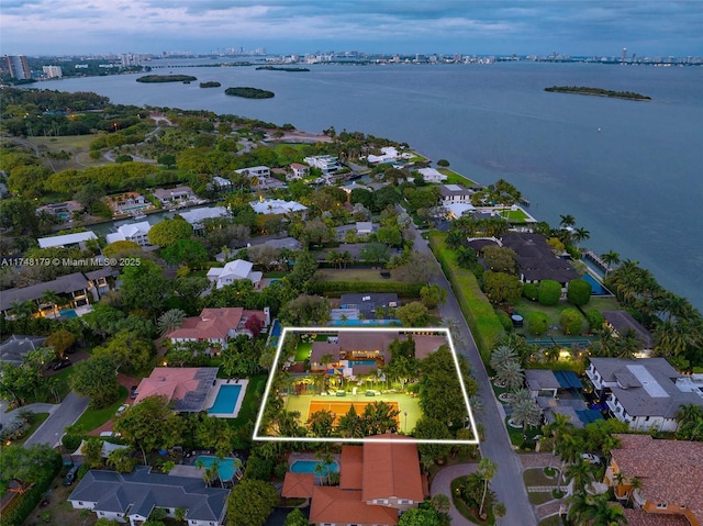 birds eye view of property with a water view and a residential view