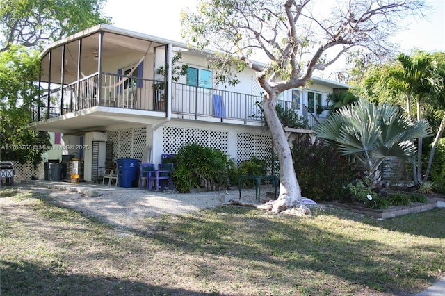544 Plante St, Key Largo, FL 33037 - view of property exterior featuring a ceiling fan, a sunroom, and a yard