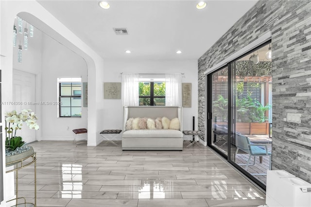 sitting room featuring recessed lighting, arched walkways, visible vents, and baseboards