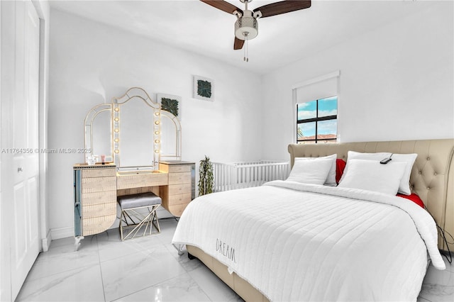 bedroom with a ceiling fan and marble finish floor