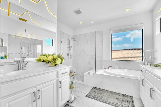 full bath with visible vents, a garden tub, a stall shower, marble finish floor, and vanity