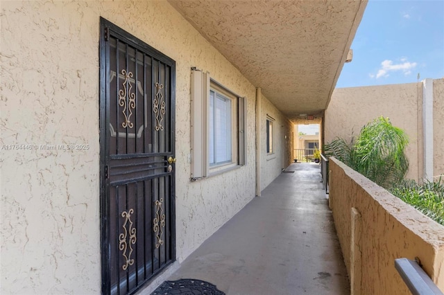 view of exterior entry featuring stucco siding